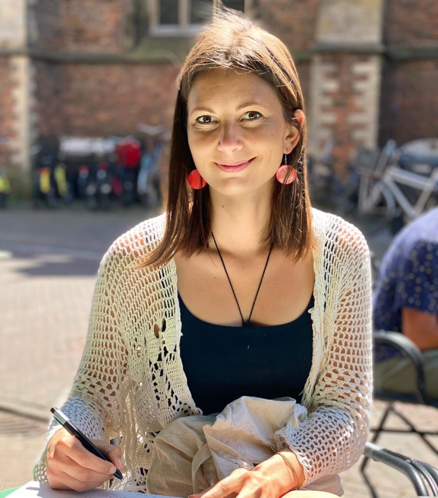 Alja Berk, certified life coach, smiling and working with clients online